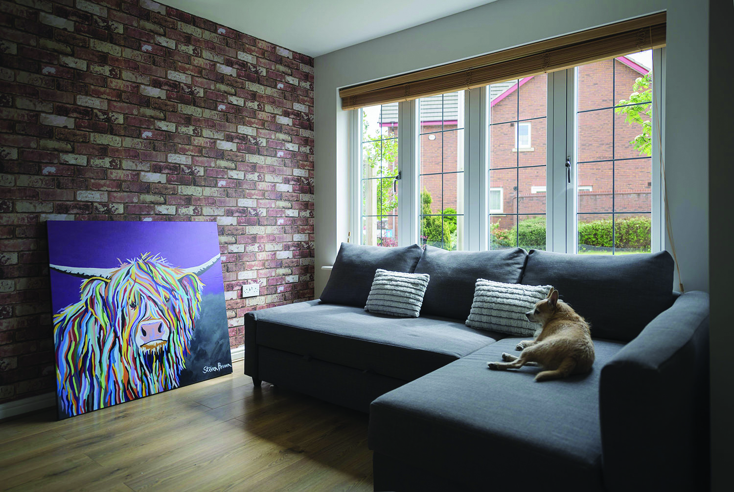 Residence 7 internal living room with dog on sofa title=