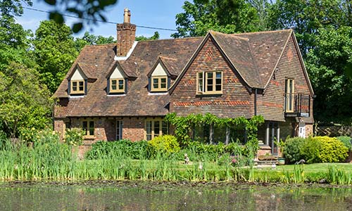 traditional home with lake facing home with timber alternative windows and doors setup throughout title=